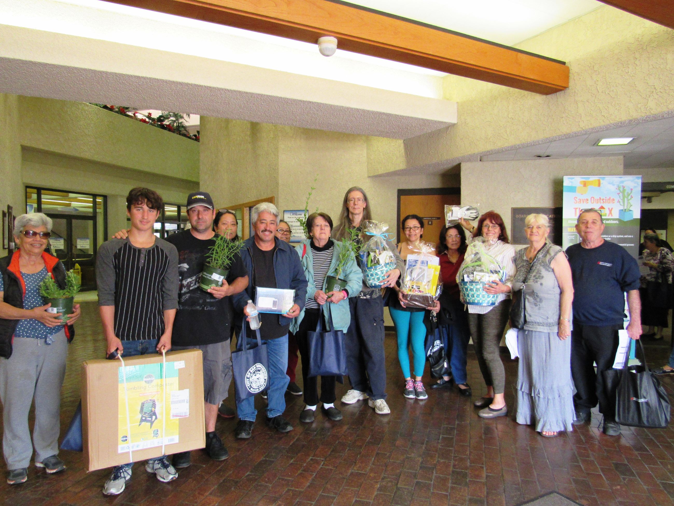 A group of people from the landscape workshop holding plants